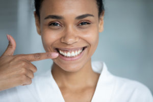 a black teen girl with straight teeth, smiling.