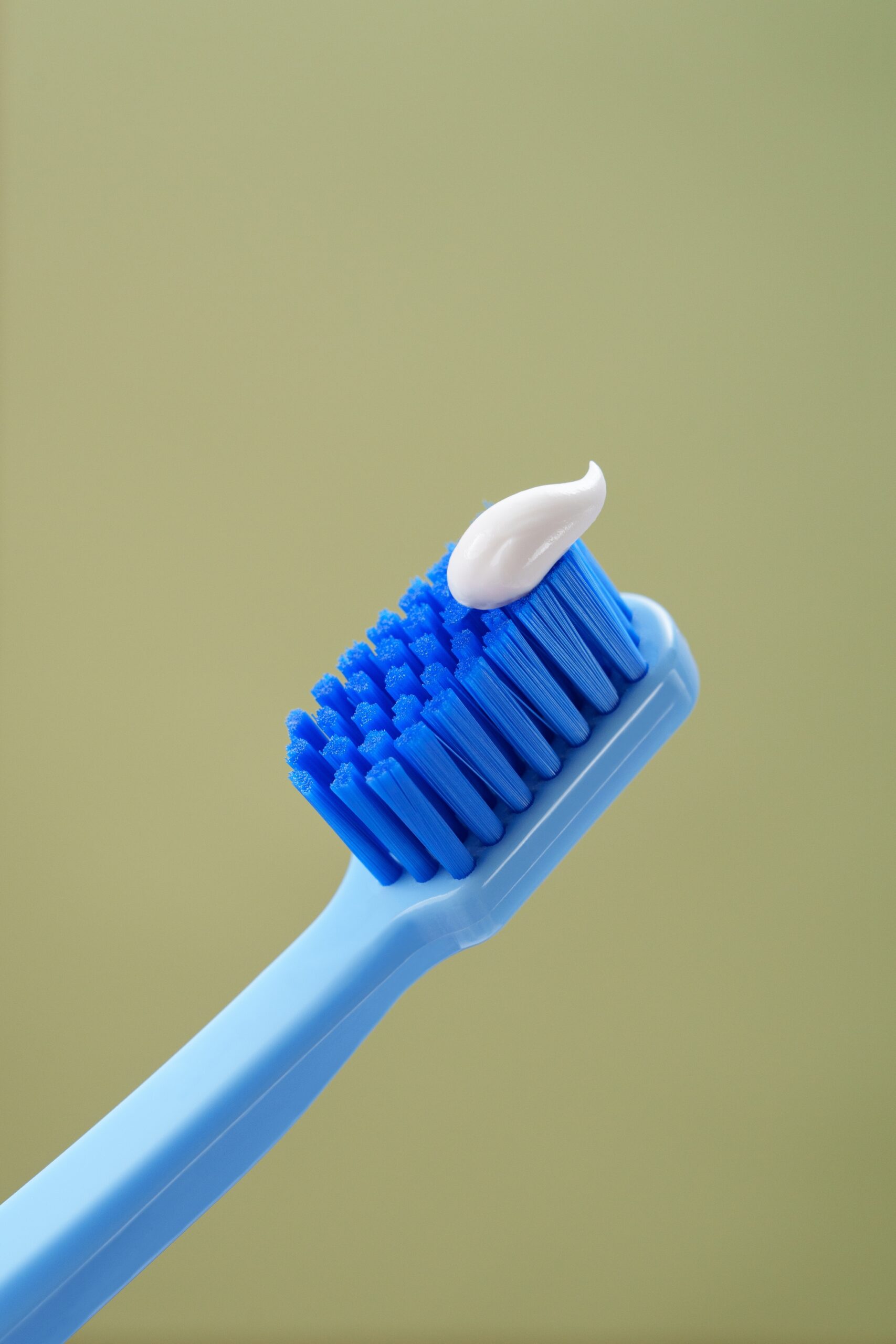 Blue toothbrush with toothpaste.