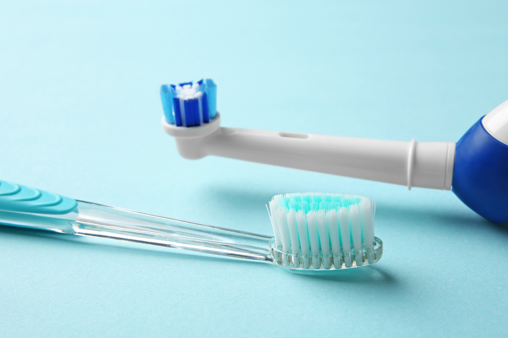 manual,and,electric,toothbrushes,on,color,background.,dental,care