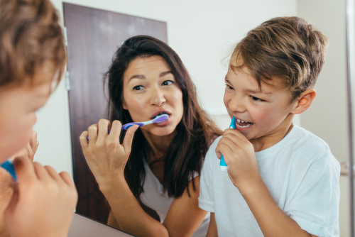 parent and child brushing teeth