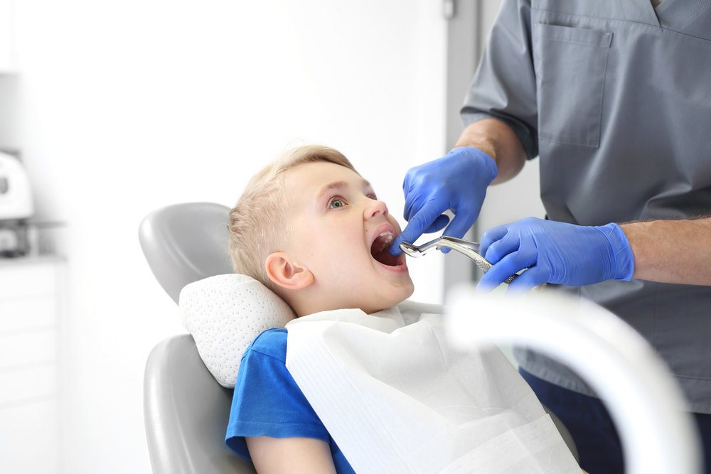 tooth extraction dental office child at the dentist