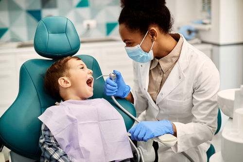 Pediatric dentist doing a check-up.