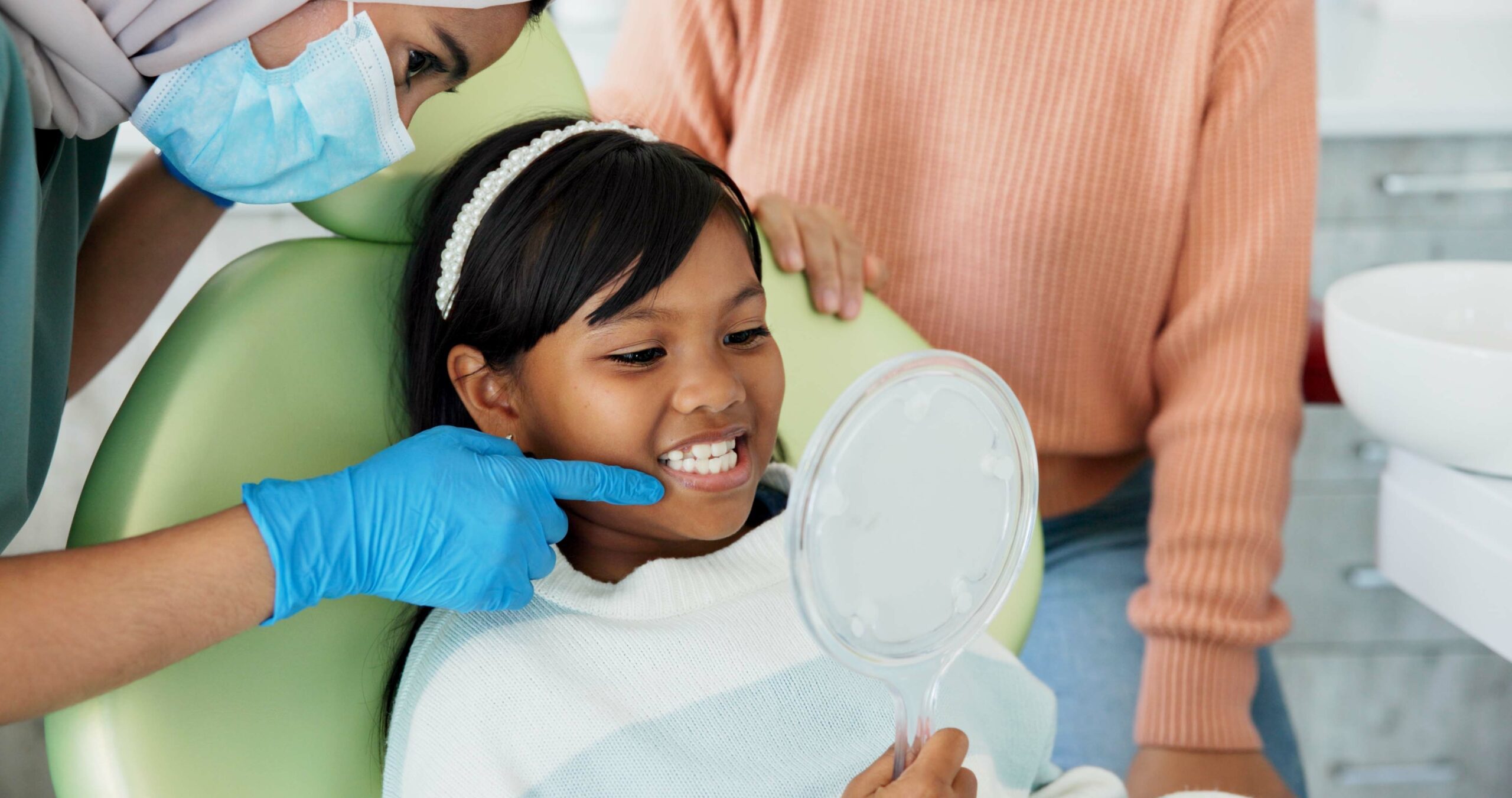 Young patient at dentist office in chair.