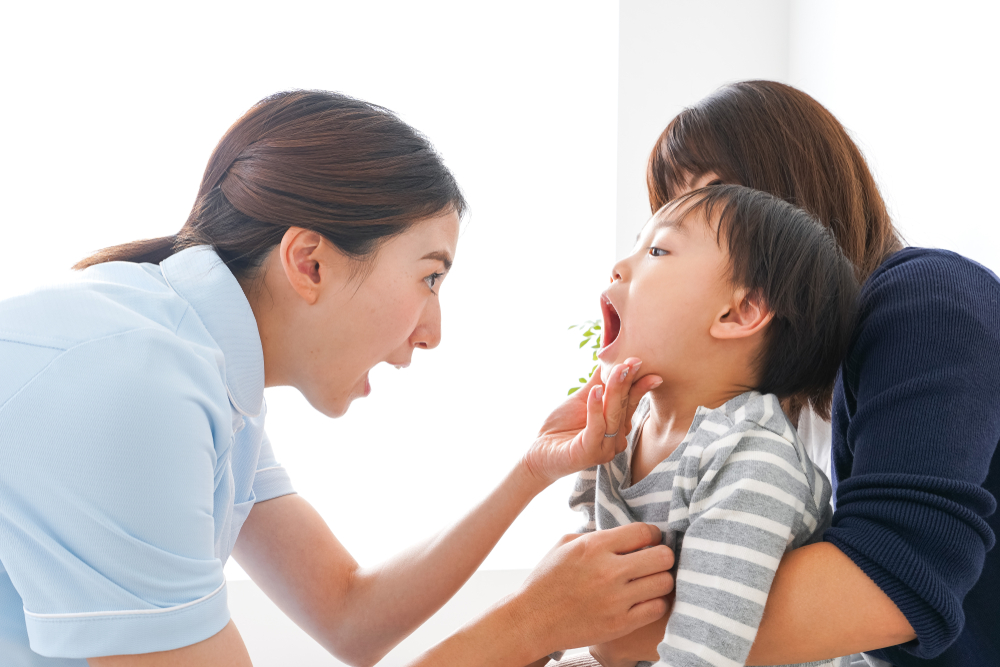 dentist,and,child dentist checking toddlers mouth during their first visit